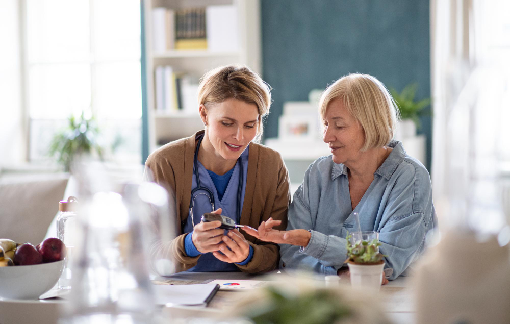 nurse-caregiver-healthcare-worker-with-senior-woman-patient-measuring-blood-glucose-indoors