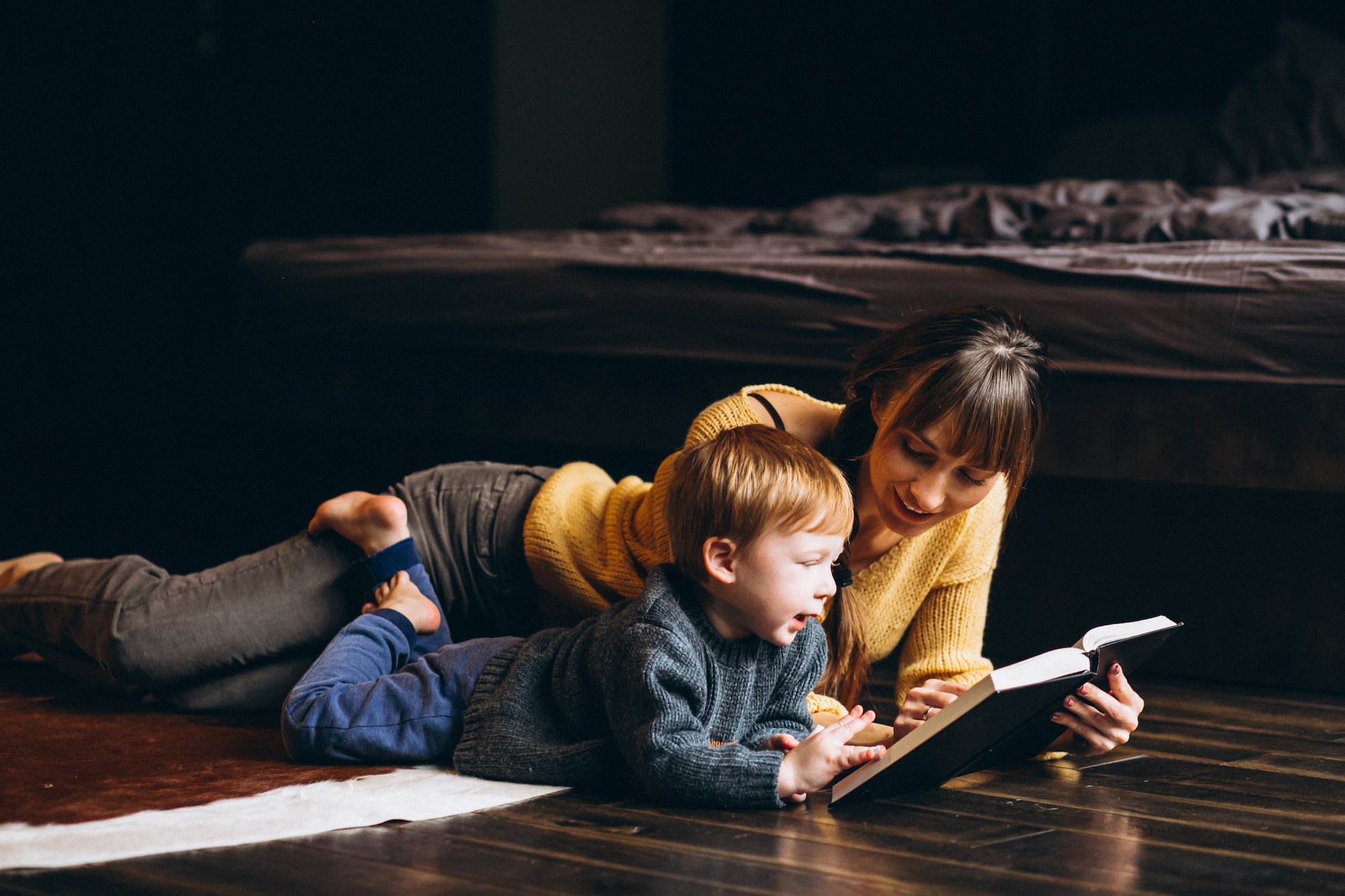 Mother with her son playing reading book